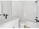 Bright bathroom showcasing a modern sink and bathtub combo with black fixtures at 81 Bridgemill Dr, Douglasville, GA 30134