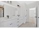 Bathroom featuring double vanity, white cabinets, and contemporary lighting at 81 Bridgemill Dr, Douglasville, GA 30134