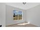 Sun-lit bedroom with a bright window looking out onto a front yard and blue skies at 81 Bridgemill Dr, Douglasville, GA 30134