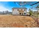Rear view of a well-maintained two-story home with a deck and spacious backyard at 81 Bridgemill Dr, Douglasville, GA 30134