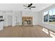 Spacious living room features a stone fireplace, modern ceiling fan, and flows into the kitchen at 81 Bridgemill Dr, Douglasville, GA 30134