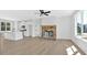 Bright living room features a stone fireplace, modern ceiling fan, and flows into the kitchen at 81 Bridgemill Dr, Douglasville, GA 30134