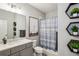 Well-lit bathroom featuring modern fixtures, stylish decor, and a shower with a blue patterned curtain at 2447 Figaro Dr, Atlanta, GA 30339