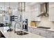 Elegant kitchen featuring white cabinets, stainless steel appliances, and a spacious countertop at 2447 Figaro Dr, Atlanta, GA 30339
