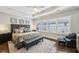 Spacious main bedroom featuring tray ceilings, natural light, stylish furnishings, and hardwood floors at 2447 Figaro Dr, Atlanta, GA 30339