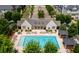 Aerial view of community pool and clubhouse showcasing lounge chairs and manicured landscaping at 2447 Figaro Dr, Atlanta, GA 30339
