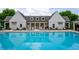 Community pool with lounge chairs surrounding the pool, in front of a large recreation center at 2447 Figaro Dr, Atlanta, GA 30339