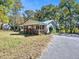 Charming single-story home with a metal roof, covered porch, and asphalt driveway at 3534 Dahlonega Hwy, Cumming, GA 30028
