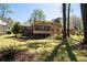 Manicured lawn with hammock; deck attached to house with multiple windows at 1542 Riderwood Ct, Decatur, GA 30033