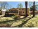 Large backyard featuring a well-maintained lawn, a deck, and mature trees at 1542 Riderwood Ct, Decatur, GA 30033