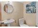 Bathroom featuring a modern toilet, sink with pedestal and octopus artwork at 1542 Riderwood Ct, Decatur, GA 30033