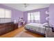 This bedroom features hardwood floors, a ceiling fan, and a dedicated study space at 1542 Riderwood Ct, Decatur, GA 30033