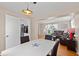 Open dining room with white table and chairs that flows seamlessly into the living room at 1542 Riderwood Ct, Decatur, GA 30033