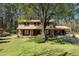 Inviting two-story home with a brick facade, lush lawn, and mature trees providing shade and curb appeal at 1542 Riderwood Ct, Decatur, GA 30033