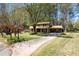 Charming two-story home with a lush front lawn, long driveway, and attached carport, nestled among mature trees at 1542 Riderwood Ct, Decatur, GA 30033