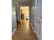 Inviting hallway with hardwood floors leading to living area with fireplace at 1542 Riderwood Ct, Decatur, GA 30033