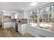 Spacious kitchen with white cabinets, stainless steel appliances, granite countertops and view to outdoors at 1542 Riderwood Ct, Decatur, GA 30033