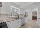 Modern kitchen with granite countertops, white cabinetry, stainless steel appliances, and wood-look flooring at 1542 Riderwood Ct, Decatur, GA 30033