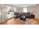 Comfortable living room with hardwood floors, a sectional sofa, and large windows offering natural light at 1542 Riderwood Ct, Decatur, GA 30033