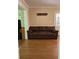 Cozy living room with hardwood floors and a comfortable brown sofa at 1542 Riderwood Ct, Decatur, GA 30033