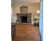 Living room featuring a brick fireplace with wood flooring and neutral paint at 1542 Riderwood Ct, Decatur, GA 30033