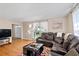 Bright living room with hardwood floors, leather sectional, and bright windows allowing ample sunlight at 1542 Riderwood Ct, Decatur, GA 30033