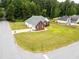 Aerial view showcasing the property's lawn and landscaping in a wooded neighborhood at 15 Fairwoods Ct, Covington, GA 30016