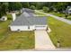 Aerial view of the home showing the backyard, driveway, and surrounding neighborhood at 15 Fairwoods Ct, Covington, GA 30016