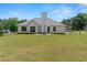 Expansive backyard with a patio area, lush lawn, and mature trees at 15 Fairwoods Ct, Covington, GA 30016
