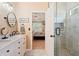 Bright bathroom featuring double vanity with a stone countertop and a glass shower door at 15 Fairwoods Ct, Covington, GA 30016