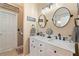 Bathroom featuring a double sink vanity with modern fixtures and round mirrors at 15 Fairwoods Ct, Covington, GA 30016