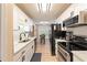 Updated kitchen features white cabinets, stainless steel appliances, and modern fixtures at 15 Fairwoods Ct, Covington, GA 30016
