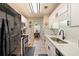 Updated kitchen features white cabinets, stainless steel appliances, and modern fixtures at 15 Fairwoods Ct, Covington, GA 30016