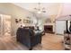 A spacious living room with a brick fireplace, modern furnishings, and hardwood floors, offering cozy ambiance at 15 Fairwoods Ct, Covington, GA 30016