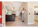 Bright living room with hardwood floors, a brick fireplace, and a ceiling fan. Great flow into the kitchen at 15 Fairwoods Ct, Covington, GA 30016