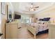 Spacious main bedroom with tray ceiling, ceiling fan, and neutral walls at 15 Fairwoods Ct, Covington, GA 30016
