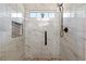 Beautiful tiled shower with a decorative mosaic inlay and pebble floor at 15 Fairwoods Ct, Covington, GA 30016