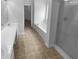 Bright bathroom with double vanity, separate shower, and soaking tub at 324 Stoney Hollow Rd, Canton, GA 30114