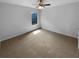 Empty bedroom featuring neutral colored walls and carpet and a ceiling fan at 324 Stoney Hollow Rd, Canton, GA 30114