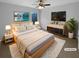 This primary bedroom offers a comfortable bed, stylish dresser, and lovely decorative details at 324 Stoney Hollow Rd, Canton, GA 30114