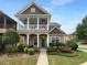 Charming two-story home featuring a welcoming front porch and well-maintained landscaping at 324 Stoney Hollow Rd, Canton, GA 30114