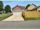 Spacious two-car garage with an expansive driveway and a partial view of the home at 324 Stoney Hollow Rd, Canton, GA 30114