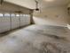 Empty two car garage with a concrete floor and an automatic door opener at 324 Stoney Hollow Rd, Canton, GA 30114