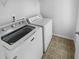 Laundry room with a new front load washing machine and dryer and tile floor at 324 Stoney Hollow Rd, Canton, GA 30114