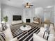 Bright living room with a fireplace, white couches, and a striped rug at 324 Stoney Hollow Rd, Canton, GA 30114