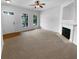 Bright living room showcasing a fireplace, large windows, and neutral carpeting at 324 Stoney Hollow Rd, Canton, GA 30114