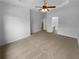 Large bedroom with tray ceiling, ceiling fan, and ensuite bathroom doorway at 324 Stoney Hollow Rd, Canton, GA 30114