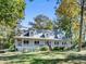 Charming home with a large, inviting wraparound porch and well-manicured front lawn at 3530 Dahlonega Hwy, Cumming, GA 30028