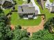 Aerial view of backyard featuring lush greenery, playset, patio area, and landscaped surroundings at 538 Mulberry Fern Dr, Auburn, GA 30011