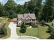 Beautiful house with mature landscaping, long driveway, and privacy fence surrounding the large backyard at 538 Mulberry Fern Dr, Auburn, GA 30011